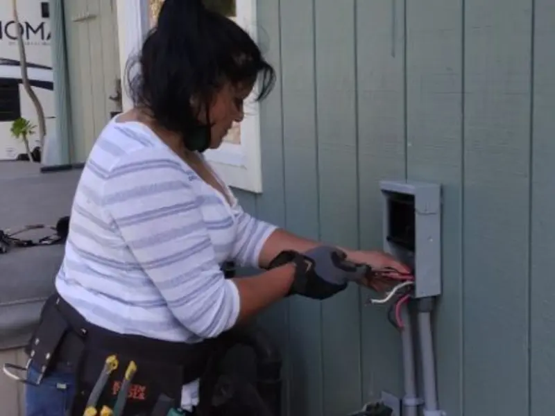 Licensed electrician wiring an exterior subpanel in Fairfax